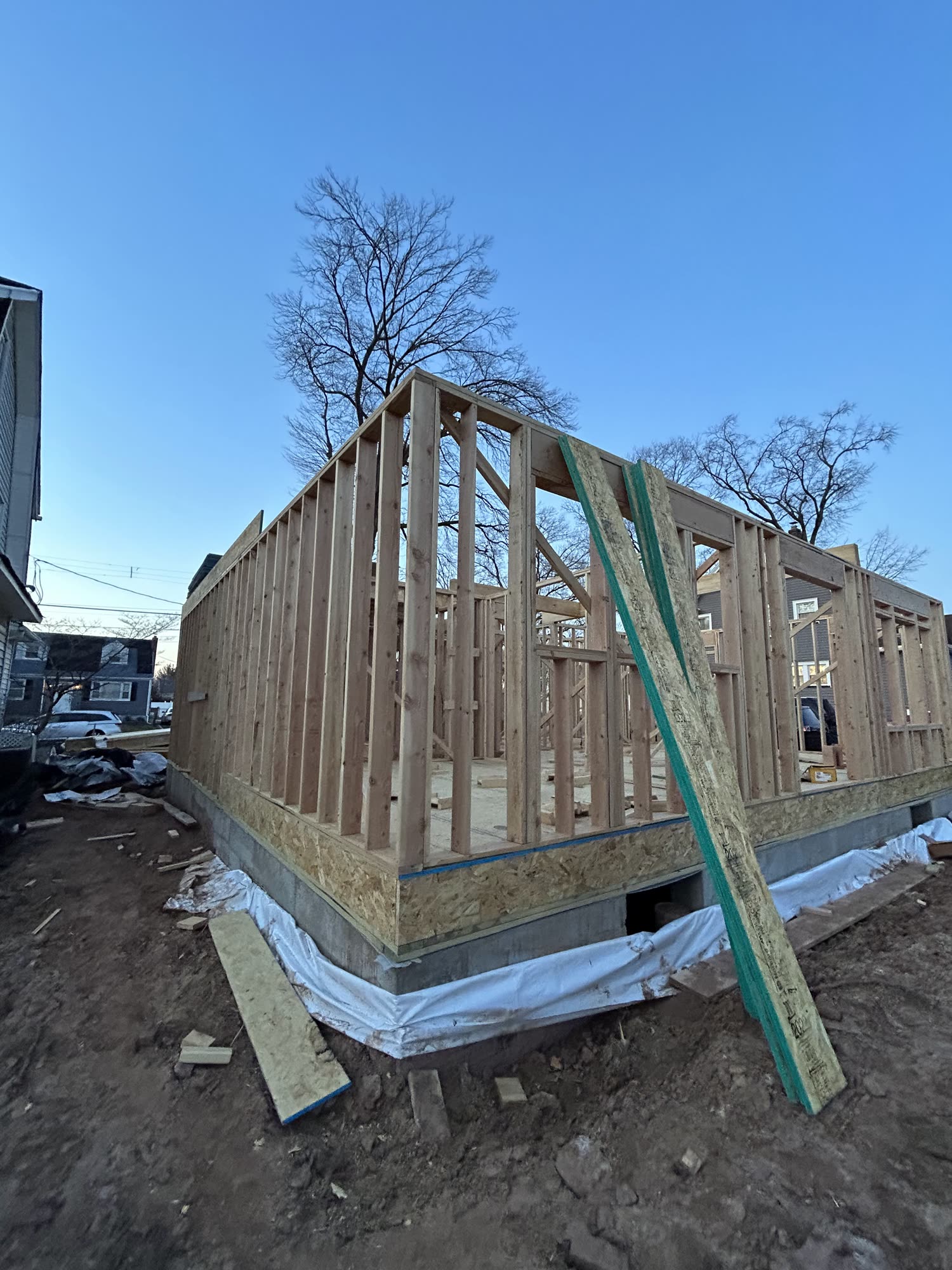 Rise Builders new-construction wood framing against a blue New Jersey sky